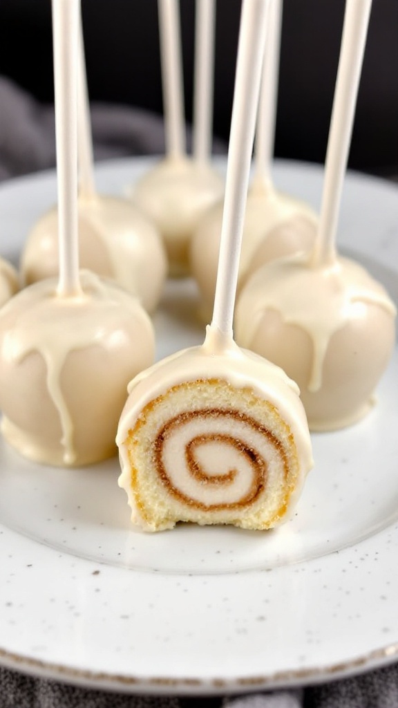 Cinnamon roll cake pops with a swirled design and sprinkled on top.