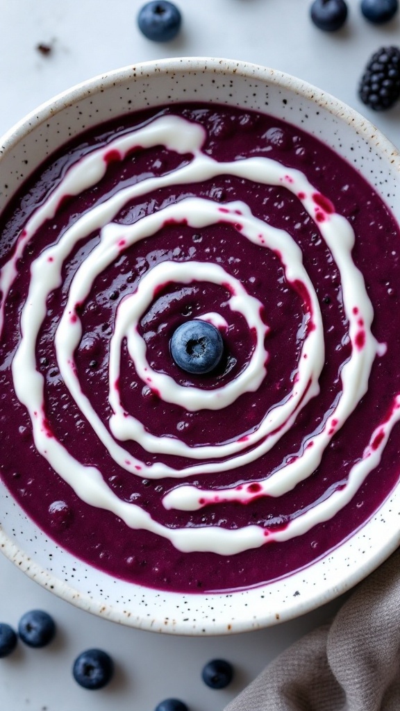 A colorful smoothie bowl topped with a spiral of coconut cream resembling a spider web.